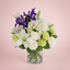 White and blue flowers arranged in a glass vase by Victoriana Florist